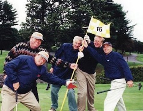 Jimmy Fund golfers on the green holding the number 16 flagstick