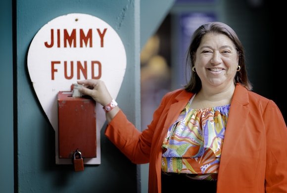 A donor giving to the Jimmy Fund at Fenway Park
