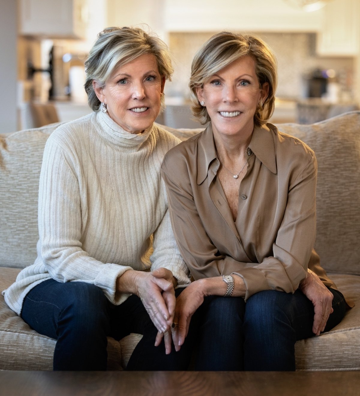 Two adult sisters sitting on a couch