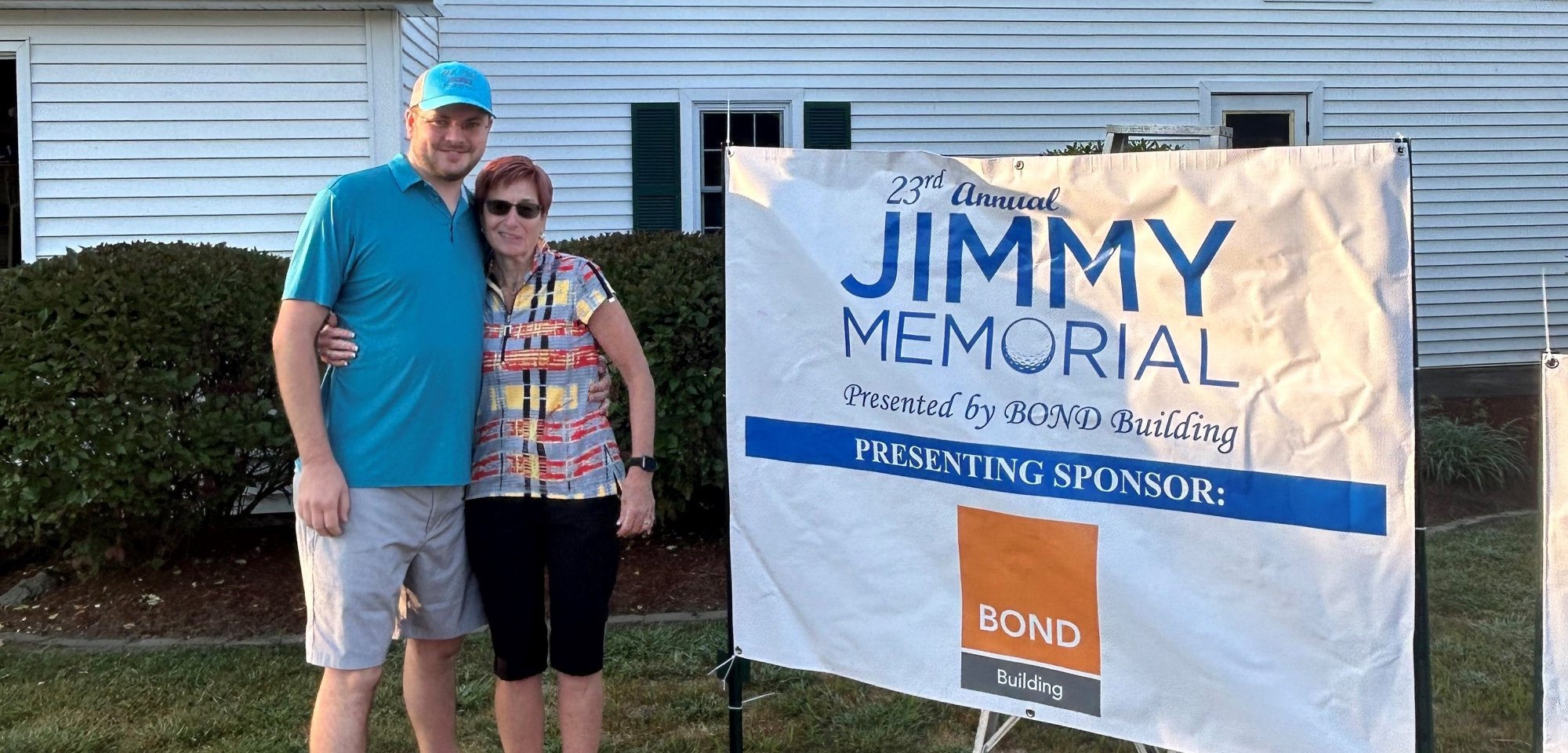 Two people next to a Jimmy Memorial sign