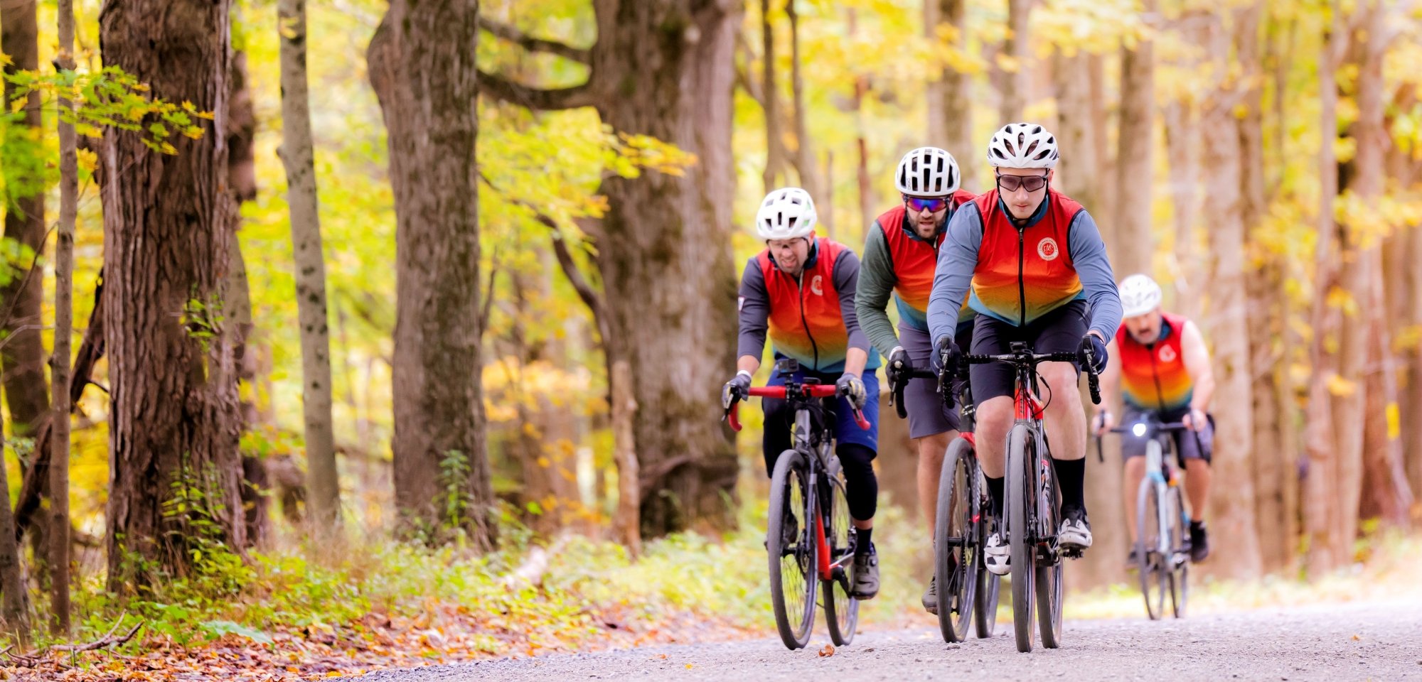 Group of riders biking in the woods with the PMC Unpaved
