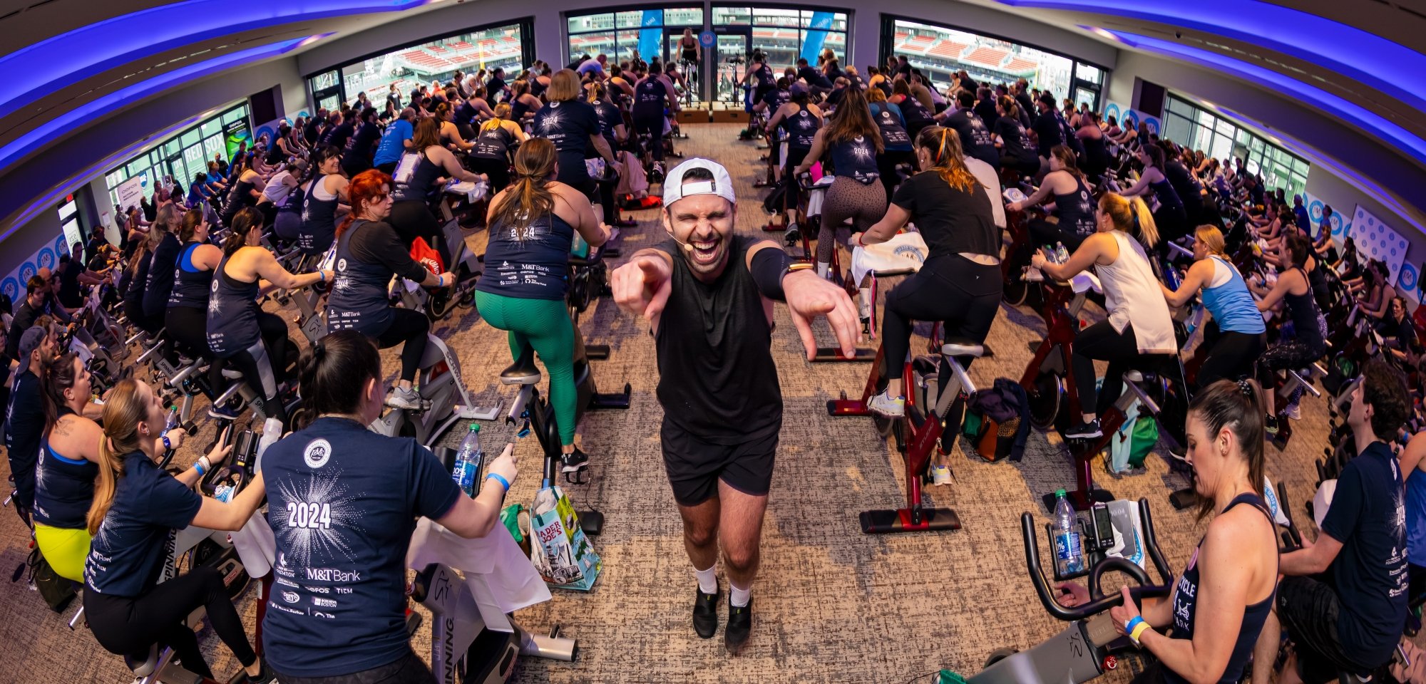 A spin instructor cheers on participants at the PMC Winter Cycle at Fenway Park