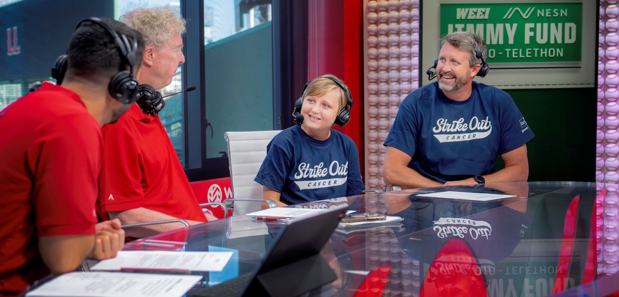 A Dana-Farber pediatric patient speaks with broadcasters at the WEEI/NESN Jimmy Fund Radio-Telethon