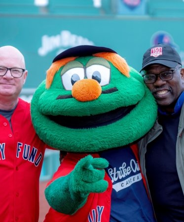 Dana-Farber Cancer Institute supporters pose with Wally the Green Monster at Fenway Park