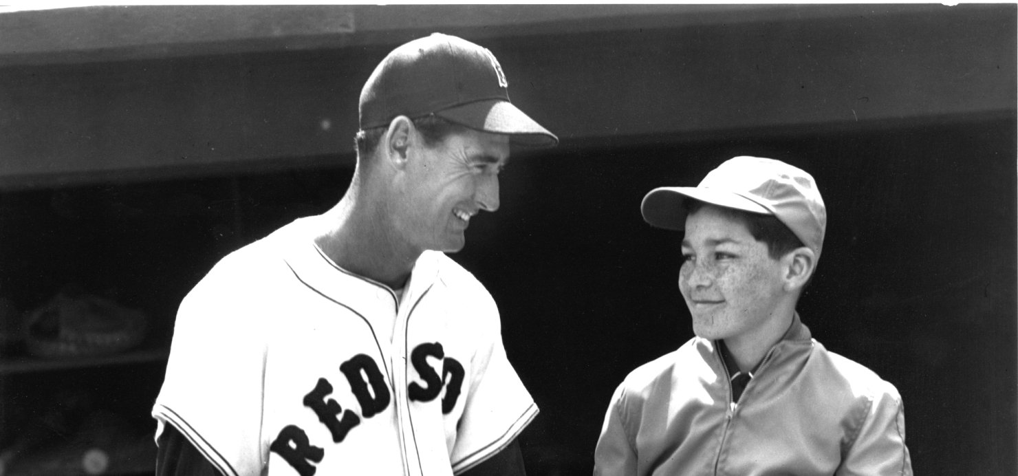 Black and white photo of Ted Williams with a patient