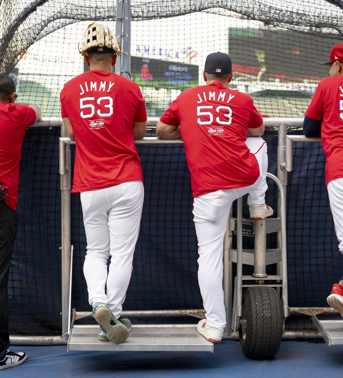 Men in Jimmy Fund shirts looking at Fenway Park