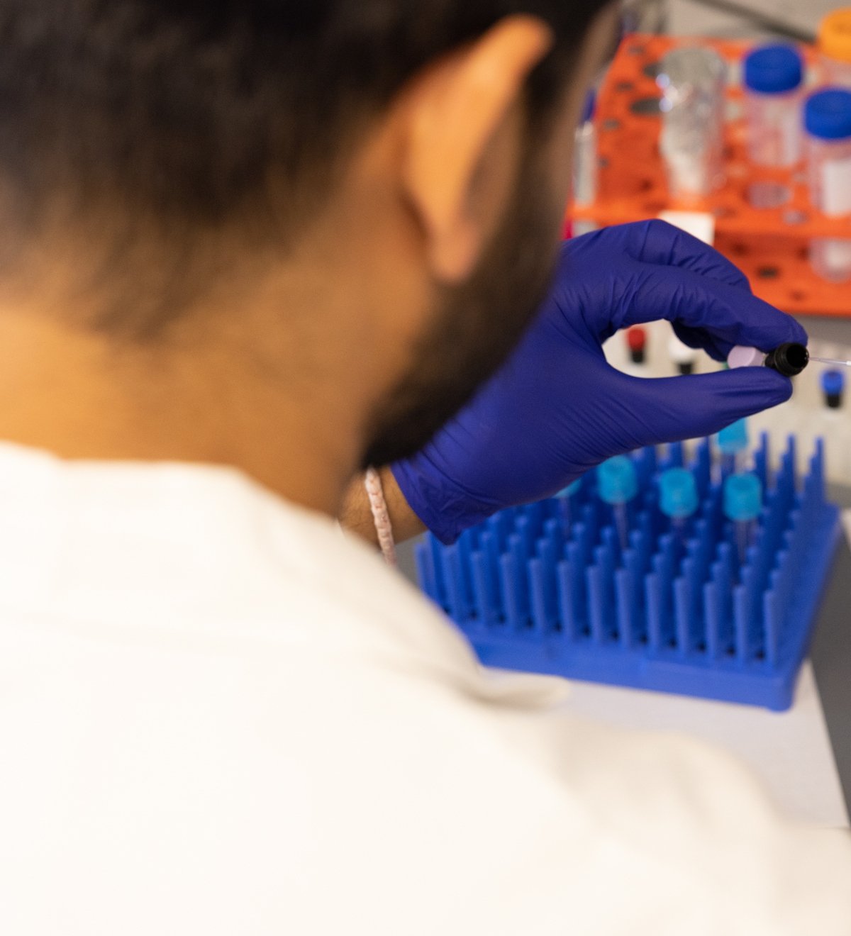 A Dana-Farber researcher works with test tubes in the lab