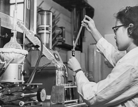 Black and white photo of a Dana-Farber Cancer Institute researcher in a laboratory