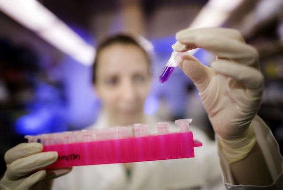 A researcher at Dana-Farber conducts an experiment in a lab