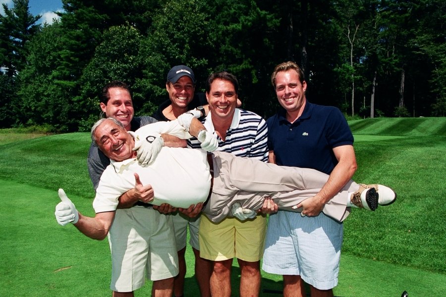 Five golfers on a golf course