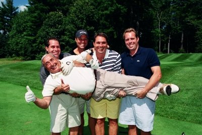 Five golfers on a golf course