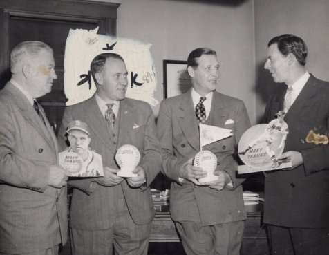 Four people hold baseballs