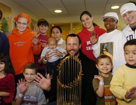 Jimmy Fund Clinic patients and Tim Wakefield with the World Series trophy