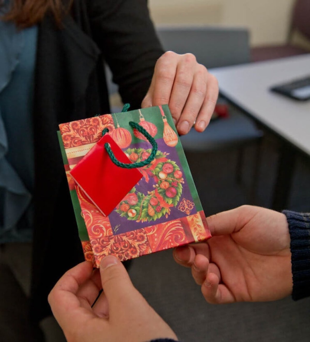 A gift bag being handed to a patient