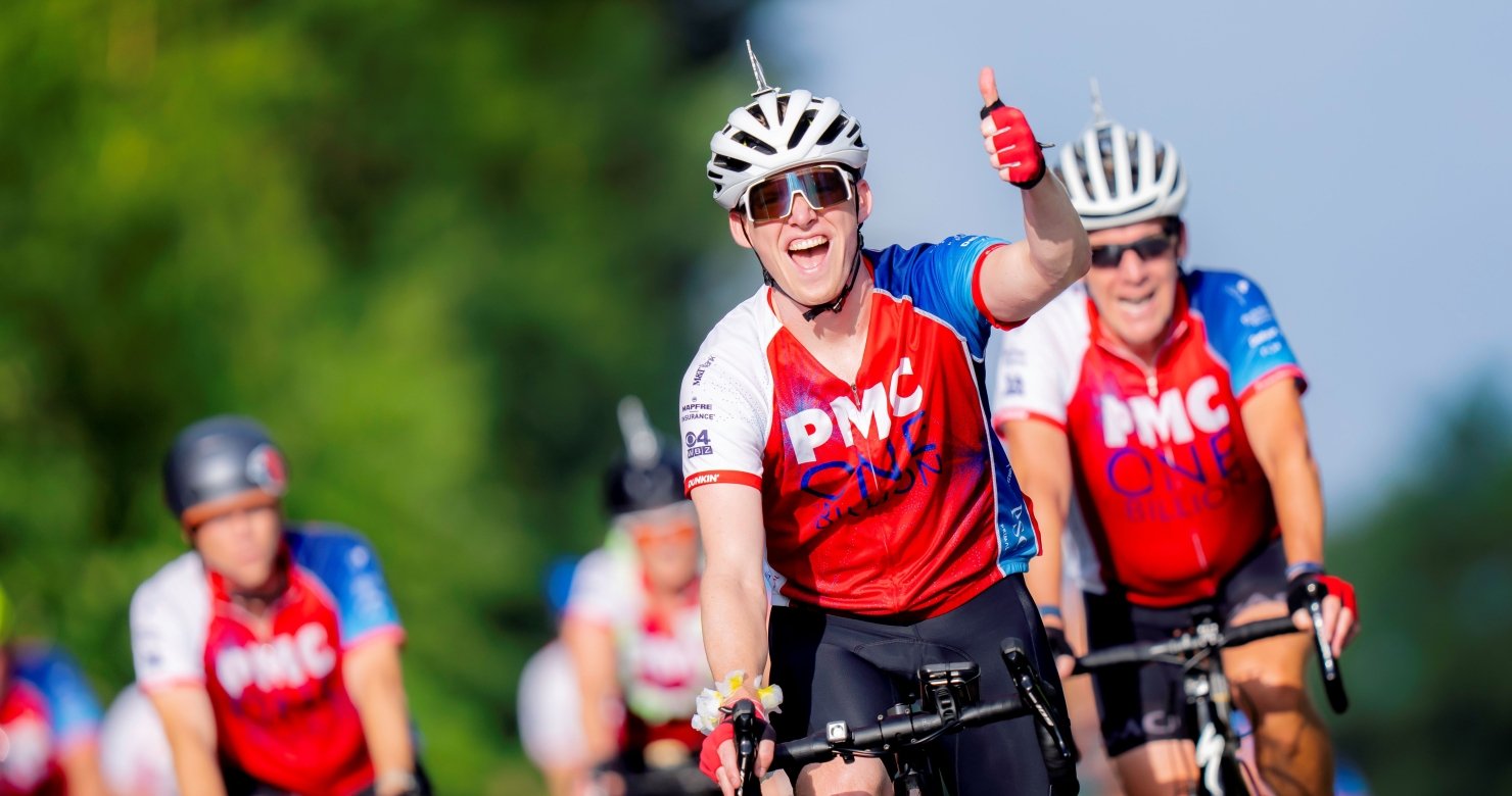 Group of PMC riders on the course giving thumbs up