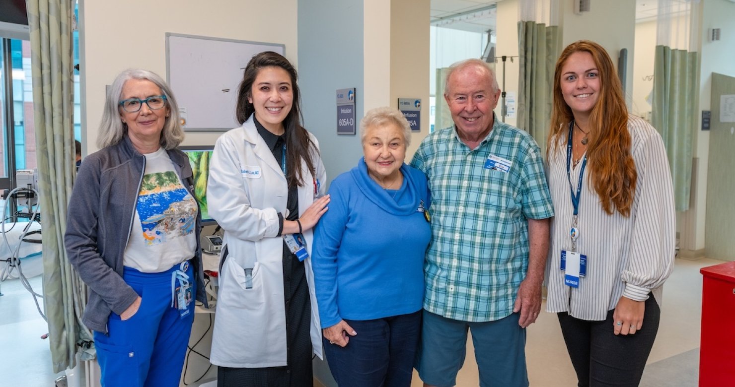 A patient, her husband, and three members of her care team in a Dana-Farber clinic