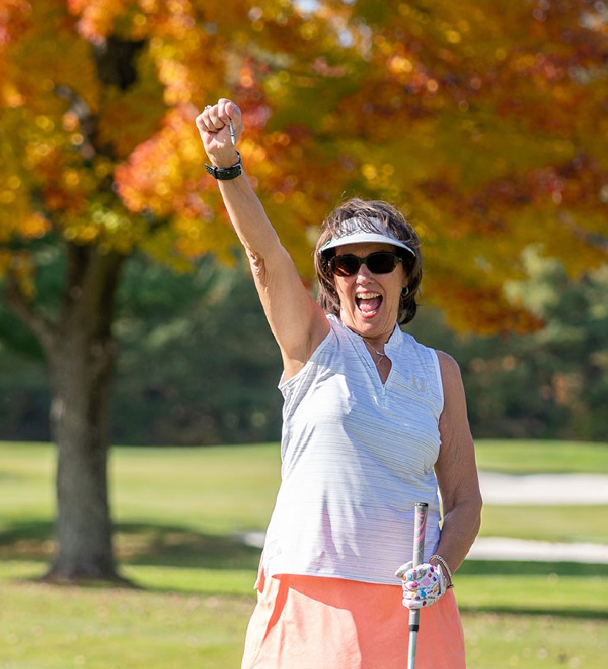 Golfer cheering on a golf course