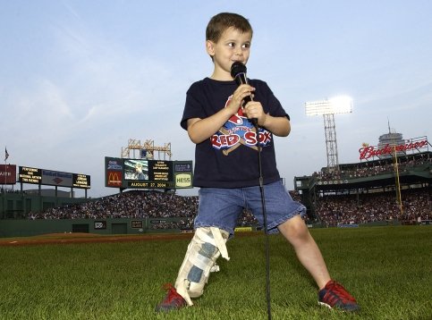 4-year-old patient sings into microphone at Fenway Park