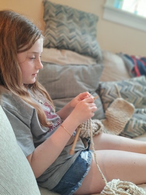 Keene knits sitting in bed