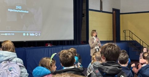 Students watching a presentation in an auditorium