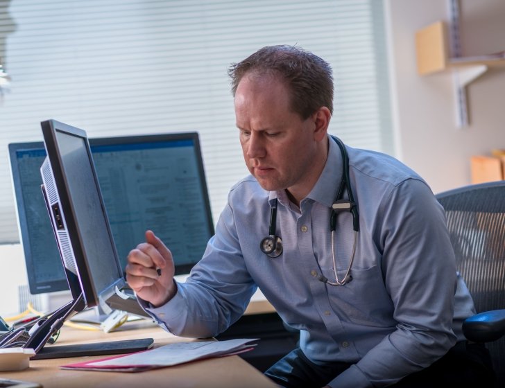 Matthew Yurgelun, MD working at his desk