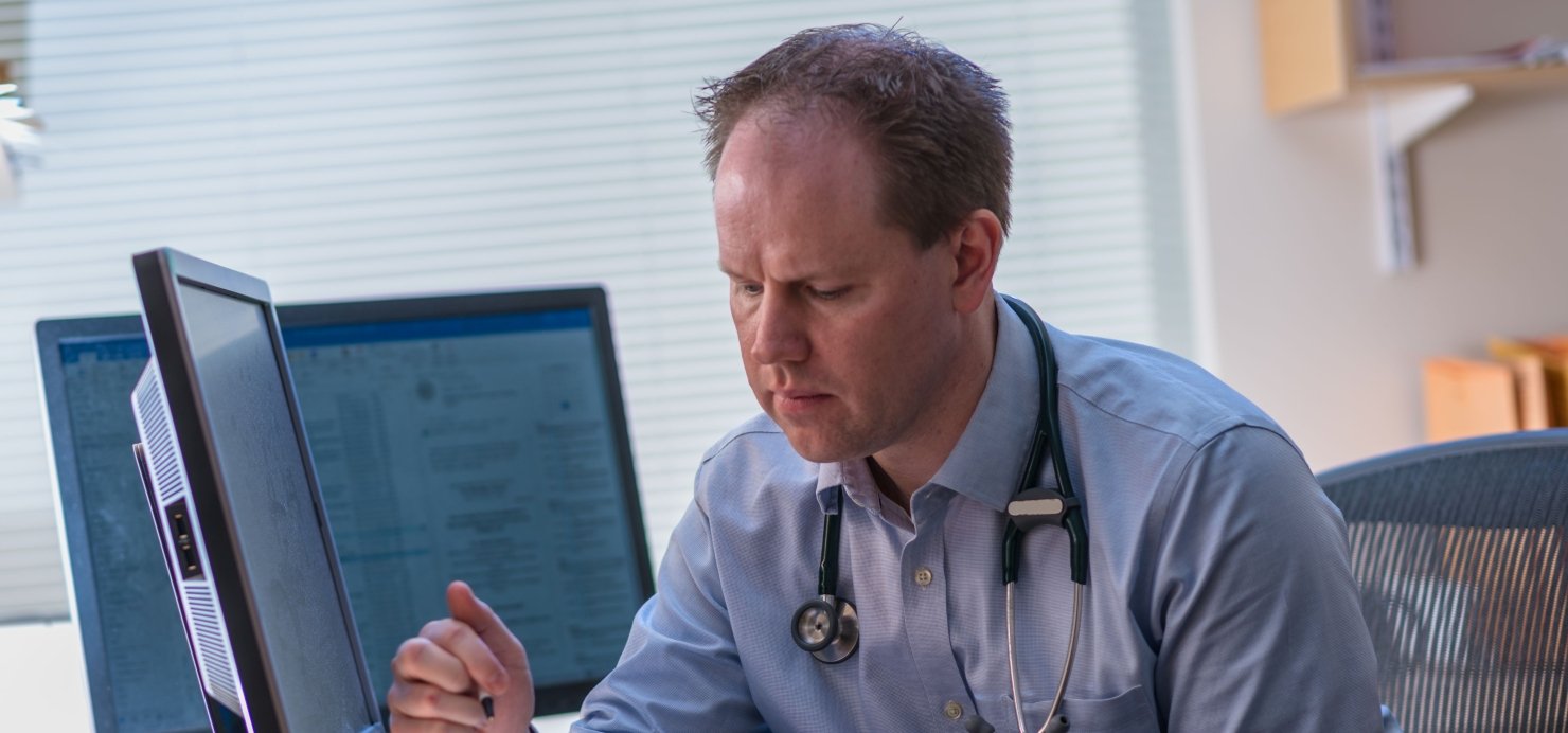 Matthew Yurgelun, MD working at his desk