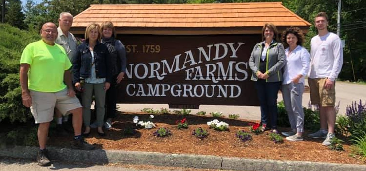 The Daniels family at a Normandy Farms Campground sign