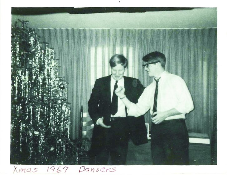 Black and white photo of Richard and Jay in front of a Christmas tree