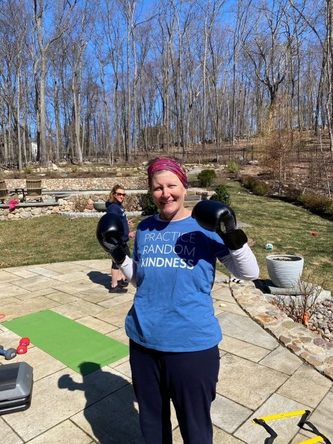 Shannon wearing workout gear and boxing gloves