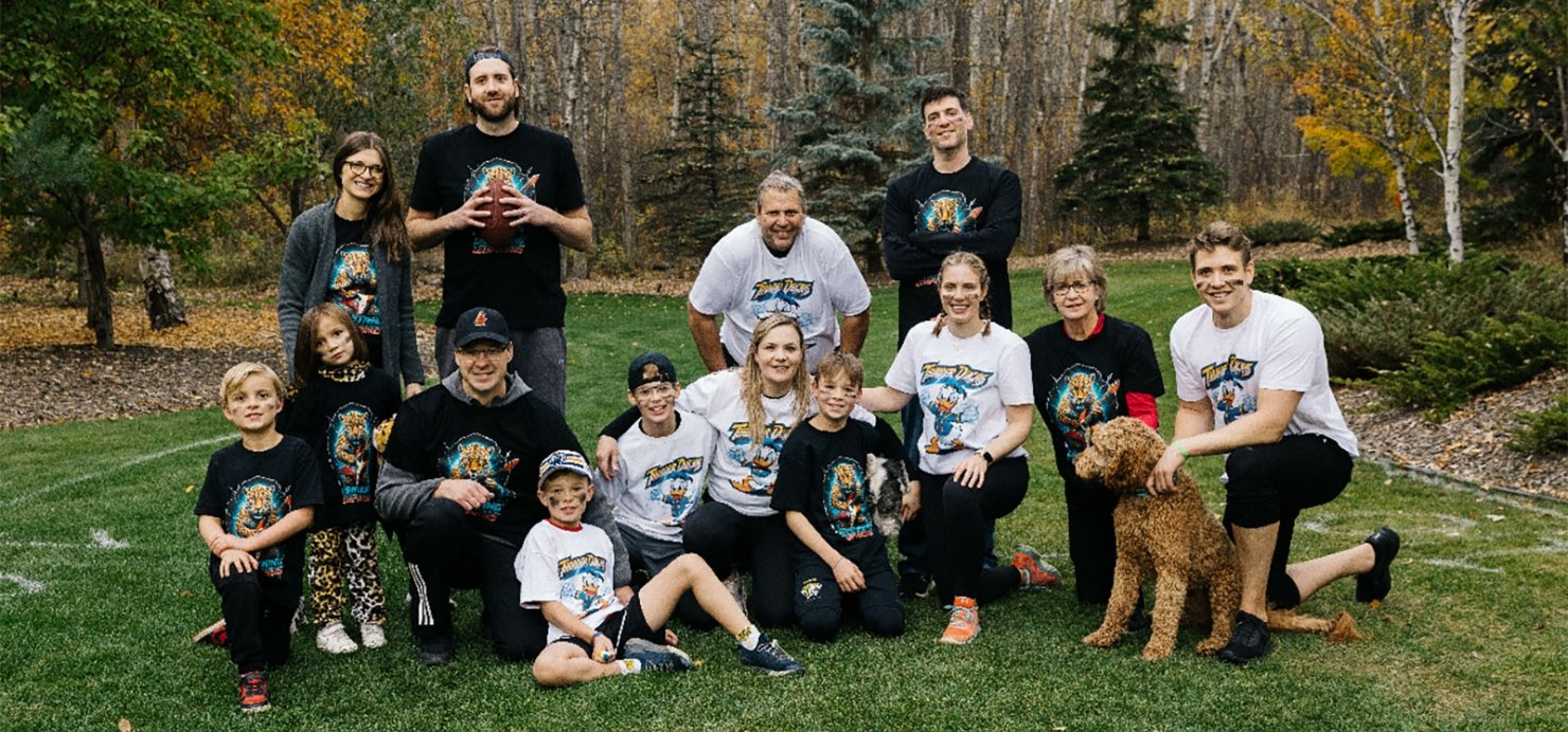 Scragg family takes a break outside during a game of football