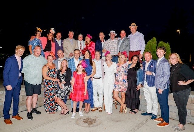 Large group, many wearing fancy hats