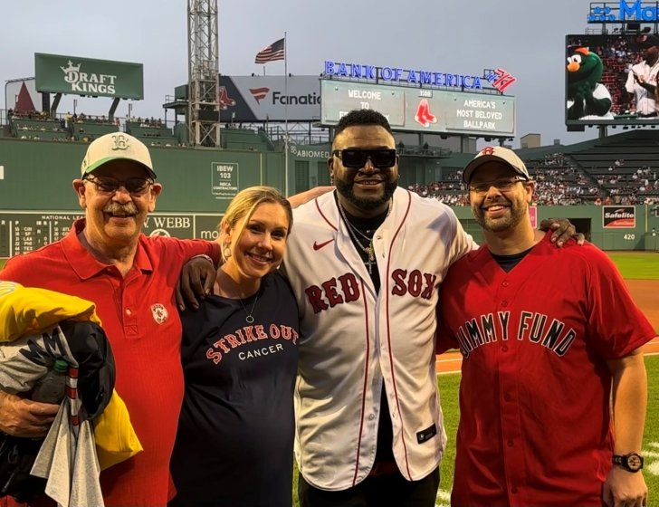 Matt with family and David Ortiz on field at Fenway Park