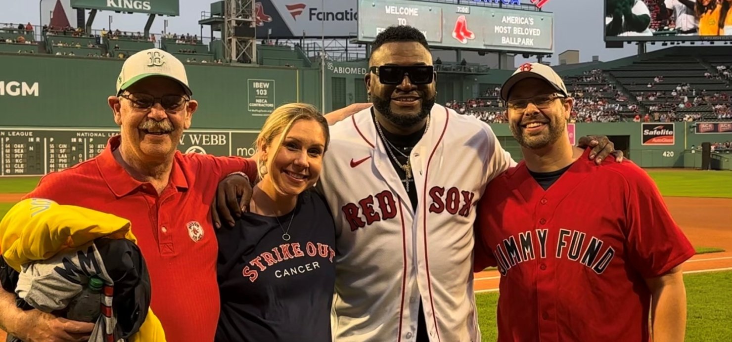 Matt with family and David Ortiz on field at Fenway Park