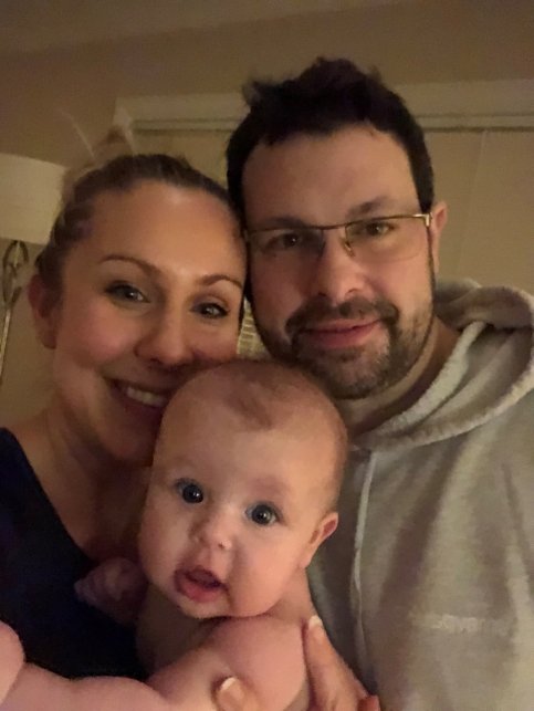 Matt and Aleah hold a baby