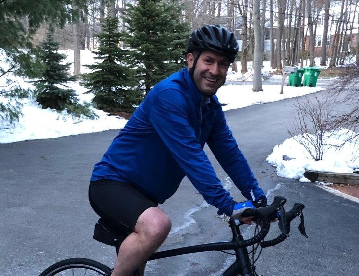 Dr. Choueiri sits on bike surrounded by snowy road