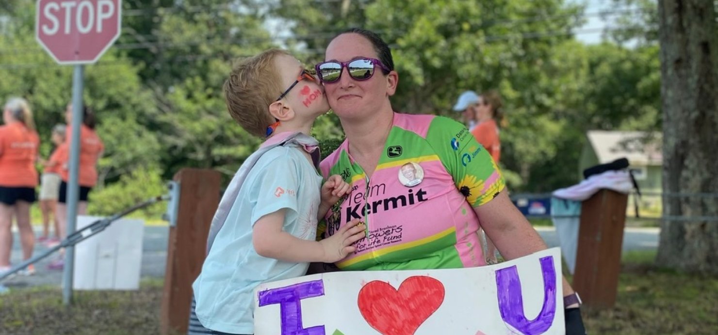 Declan kisses his mother’s cheek as she prepares for a race