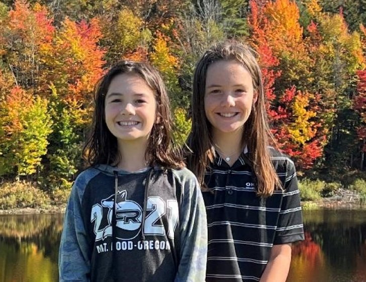 Cami and Chloe standing by a lake