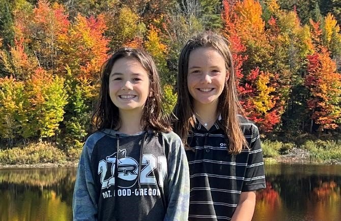 Cami and Chloe standing by a lake