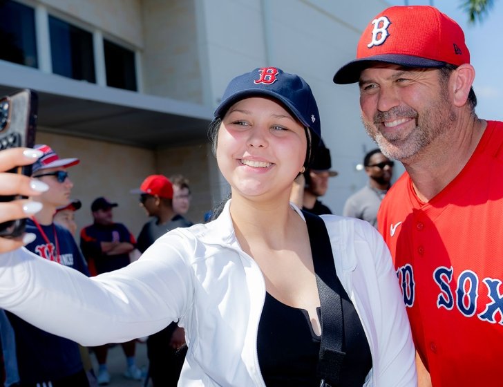 Two people in Red Sox gear take a selfie