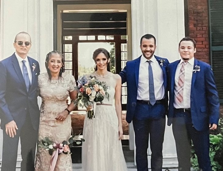 Patti stands with family dressed for wedding