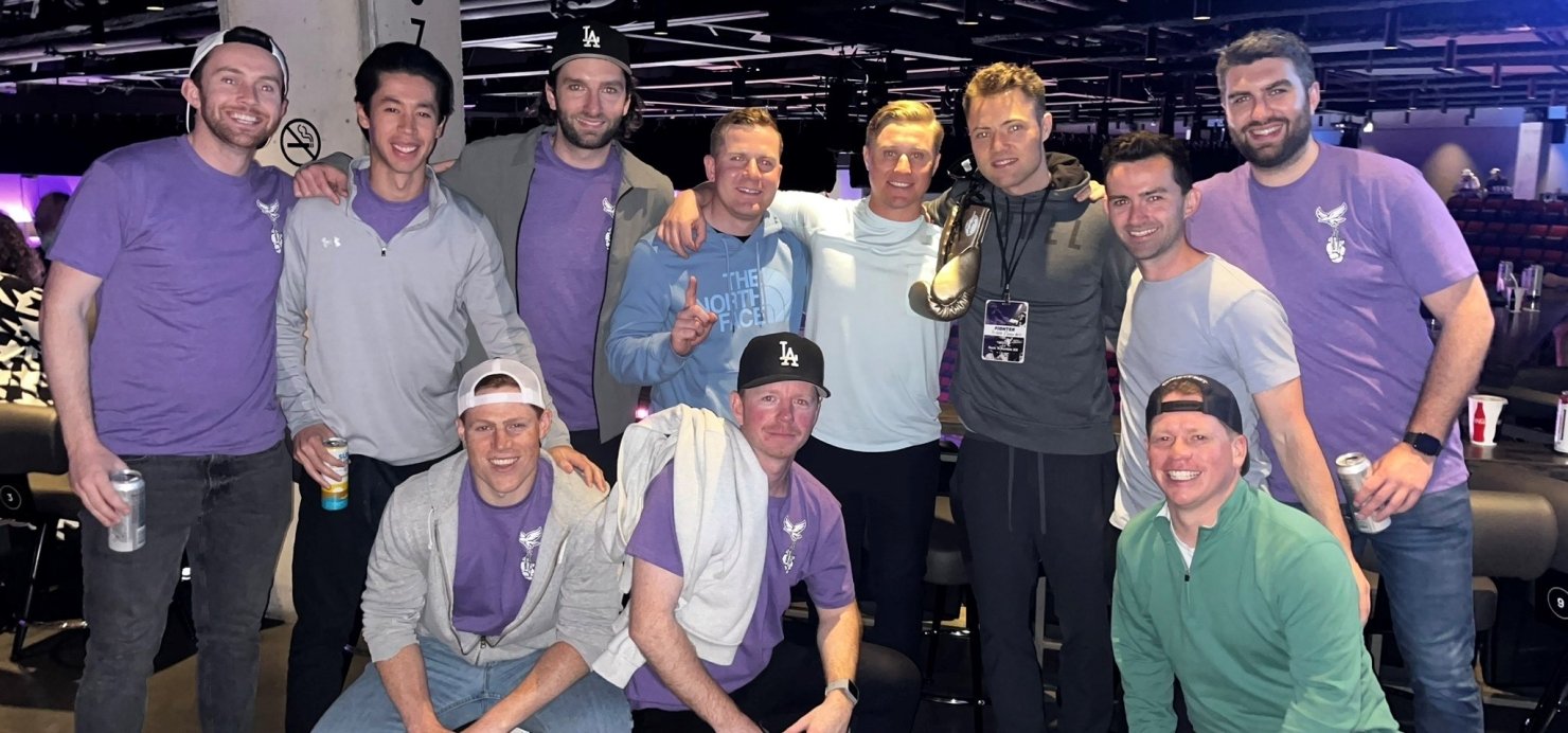 Chris surrounded by friends and family in purple 'Team Devin' shirts