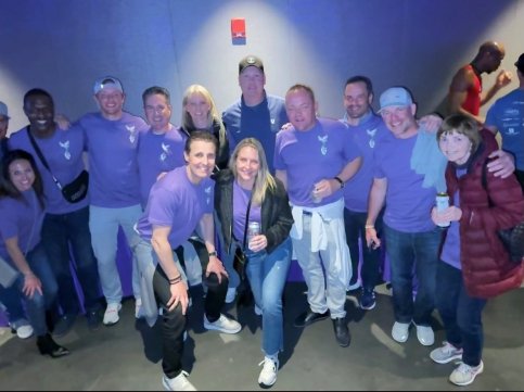 Chris with family and friends, all wearing purple 'Team Devin' shirts