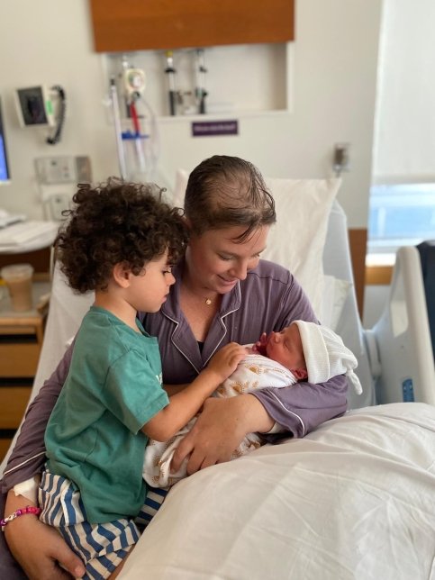 Catherine and her children in a hospital bed