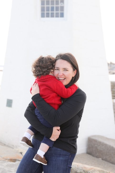 Erin hugging her child outside a lighthouse