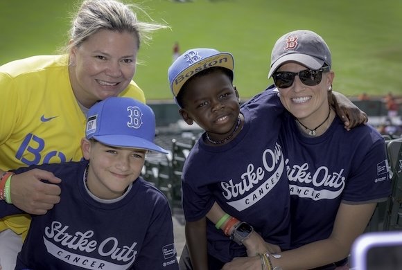 A young patient with family at Fenway Park