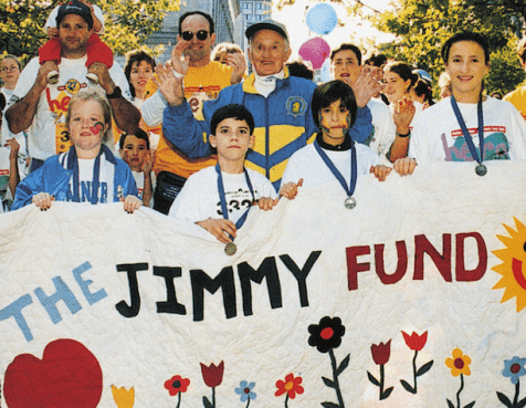 Jimmy Fund supporters holding a Jimmy Fund poster