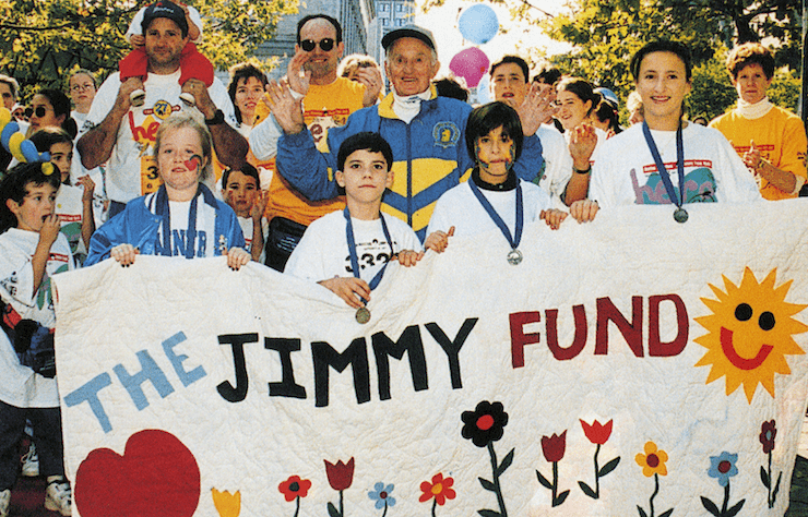 Participants holding a Jimmy Fund sign at a past Jimmy Fund Walk