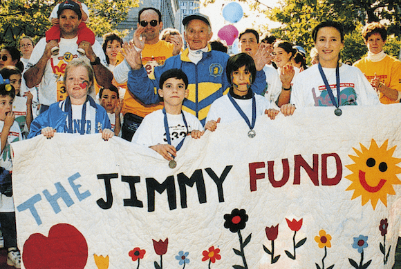 Participants holding a Jimmy Fund sign at a past Jimmy Fund Walk
