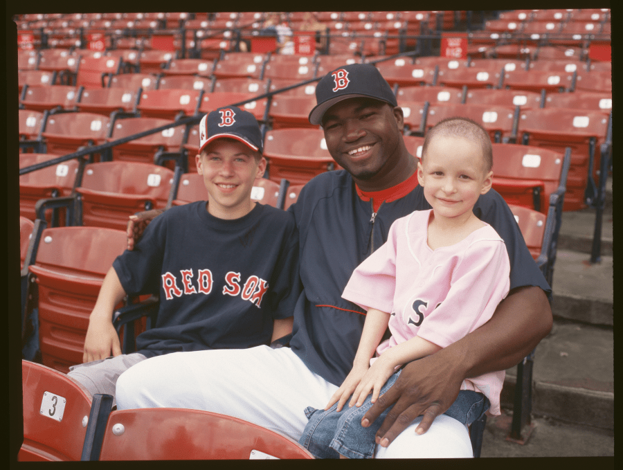 Big Papi and two children sitting in Fenway Park