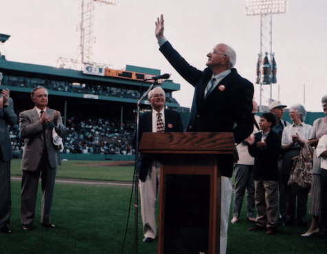 Jimmy waving at a podium in Fenway Park